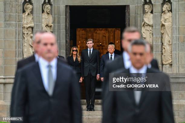Former US President Donald Trump stands with his wife Melania Trump their son Barron Trump and father-in-law Viktor Knavs , as the coffin carrying...