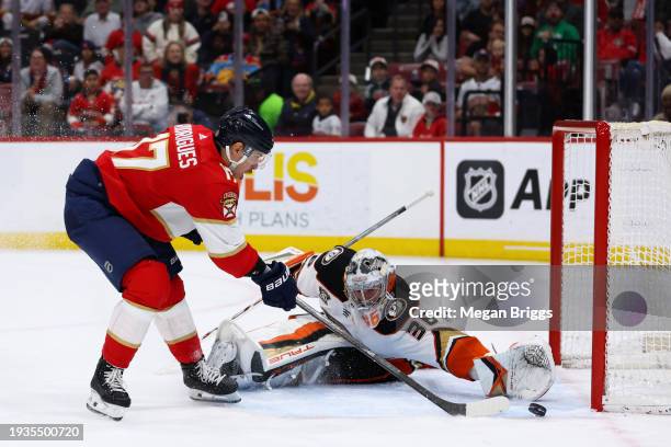 Evan Rodrigues of the Florida Panthers skates with the puck against John Gibson of the Anaheim Ducks during the second period of the game at Amerant...