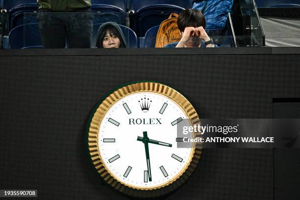 Spectators try to stay awake as the clock nears 3:30am during the 5th set of the men's singles match between Russia's Daniil Medvedev and Finland's...