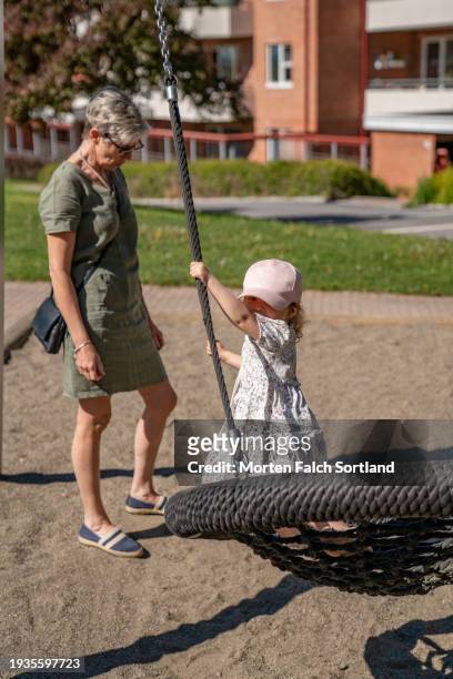 grandmother and granddaughter bonding at a playground - oslo play fotografías e imágenes de stock
