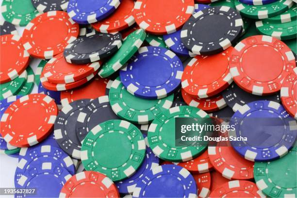 poker chips in pile on casino table - world series of poker stock pictures, royalty-free photos & images