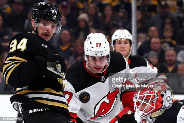 Jakub Lauko of the Boston Bruins and Simon Nemec of the New Jersey Devils stare at a loose puck during the third period at TD Garden on January 15,...