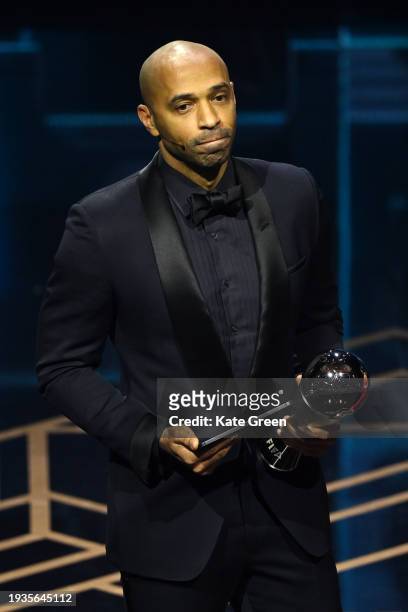 Thierry Henry reacts as he picks up the trophy for Lionel Messi as he is announced as the winner of the FIFA Best Men's Award during the The Best...