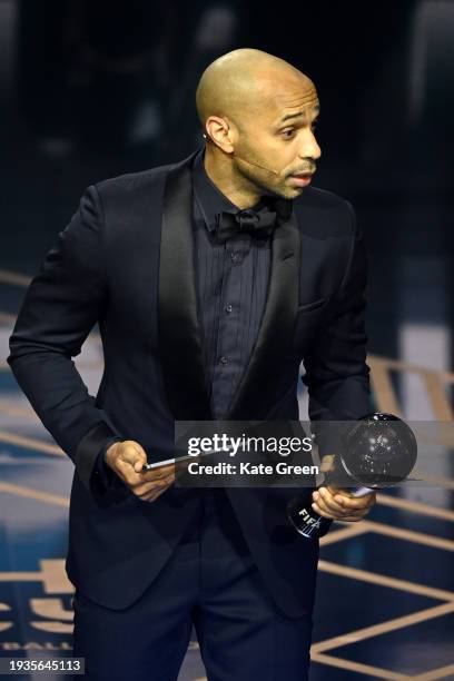 Thierry Henry reacts as he picks up the trophy for Lionel Messi as he is announced as the winner of the FIFA Best Men's Award during the The Best...