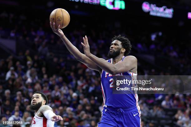 Joel Embiid of the Philadelphia 76ers shoots a lay up past Fred VanVleet of the Houston Rockets during the third quarter during the third quarter at...