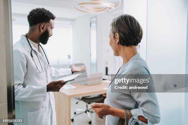 doctor receiving patient in office - data entry devices stock pictures, royalty-free photos & images