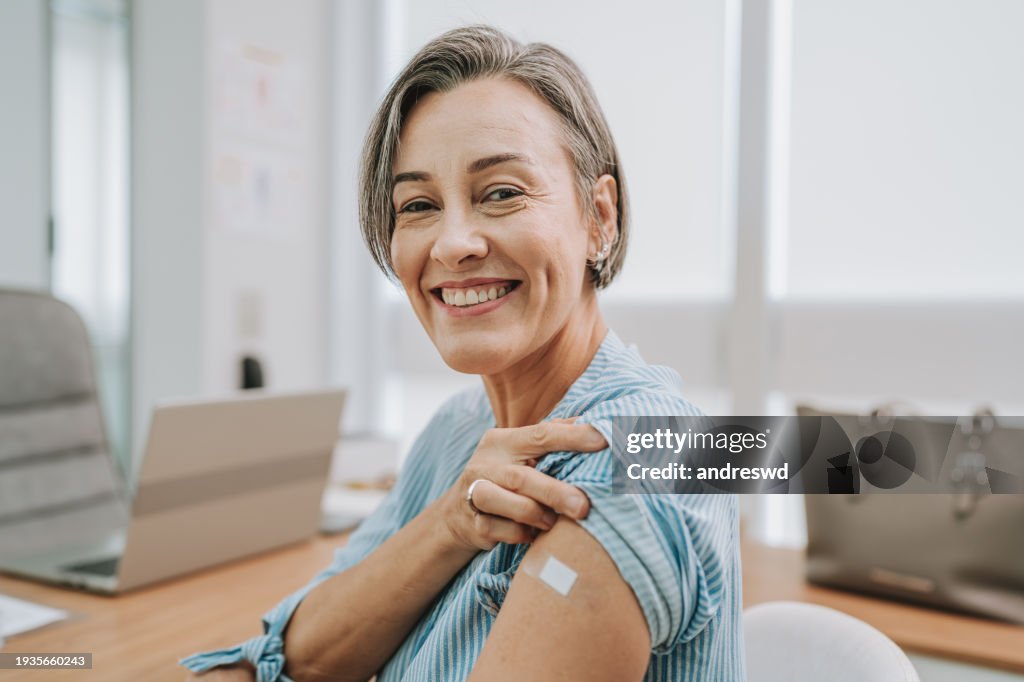Woman showing vaccinated arm