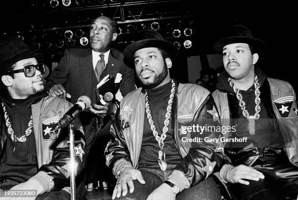 View of American educator and Eastside High School principal Joe Louis Clark with the members of American Hip Hop group Run-DMC on a stage at the...