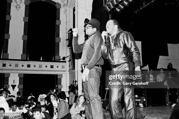 American Hip Hop musicians Darryl 'DMC' McDaniels and Joseph 'Run' Simmons, both of group Run-DMC, perform onstage at Eastside High School, Paterson,...