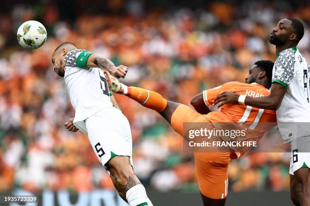 Nigeria's defender William Troost-Ekong fights for the ball with Ivory Coast's forward Jean-Philippe Krasso during the Africa Cup of Nations 2024...