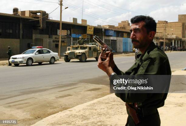 An Iraqi policeman patrols a street during joint operations with U.S. Soldiers April 16, 2003 in Baghdad, Iraq. A senior U.S. Army officer said today...