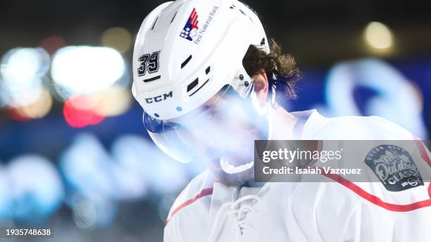 The Outdoor Classic is reflected as Brendan Perlini of Charlotte Checkers looks on during the second period against the Rochester Americans during...
