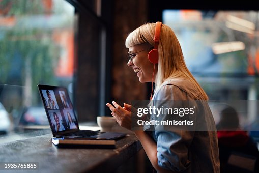 Portrait of a Cheerful Beautiful Young Woman Having an Online Meeting on Her Laptop in the Cafeteria (Copy Space) Portrait of a Cheerful Beautiful Young Woman Having an Online Meeting on Her Laptop in the Cafeteria (Copy Space)