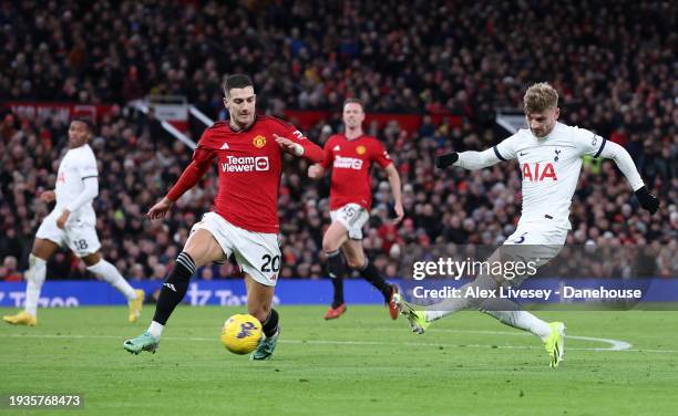 Timo Werner of Tottenham Hotspur shoots past Diogo Dalot of Manchester United during the Premier League match between Manchester United and Tottenham...