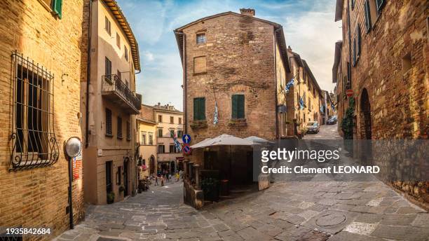 wide angle view of steep narrow cobblestone streets in the medieval old town of montepulciano, siena province, tuscany, italy. - siena italy stock pictures, royalty-free photos & images