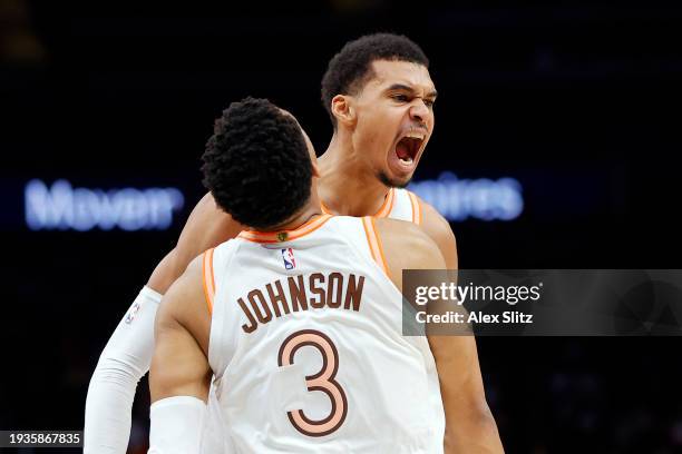 Victor Wembanyama of the San Antonio Spurs celebrates with Keldon Johnson during the second half against the Atlanta Hawks at State Farm Arena on...