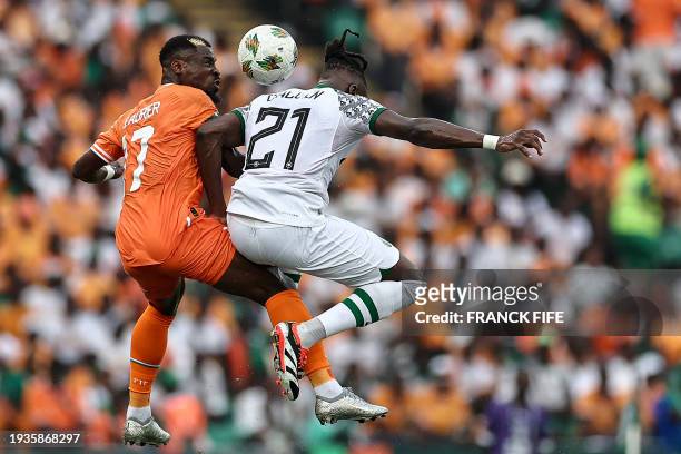Ivory Coast's defender Serge Aurier fights for the ball with Nigeria's defender Calvin Bassey during the Africa Cup of Nations 2024 group A football...