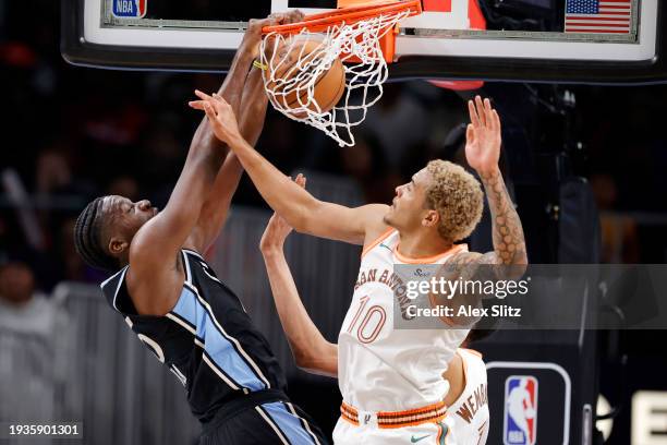 Clint Capela of the Atlanta Hawks dunks the ball over Jeremy Sochan of the San Antonio Spurs during the second half at State Farm Arena on January...