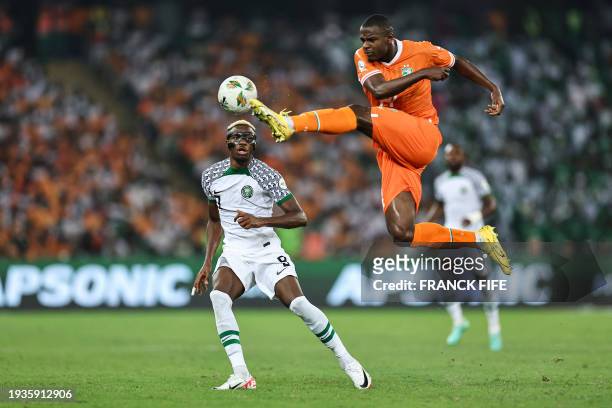 Nigeria's forward Victor Osimhen fights for the ball with Ivory Coast's defender Evan Ndicka during the Africa Cup of Nations 2024 group A football...