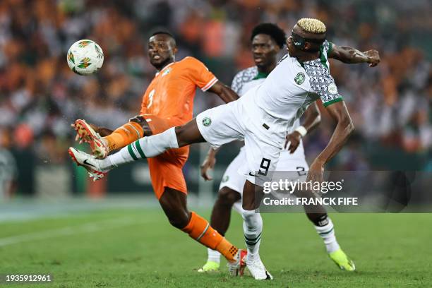 Nigeria's forward Victor Osimhen fights for the ball with Ivory Coast's defender Ghislain Konan during the Africa Cup of Nations 2024 group A...
