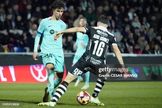 Barcelona's Portuguese forward Joao Felix fights for the ball with Unionistas' Spanish midfielder Adrian Gomez during the Spanish Copa del Rey...