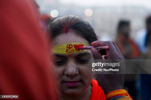 Devotee is writing 'Jai Shri Ram' on her forehead in Ayodhya, Uttar Pradesh, India, on January 18, 2024. The temple is scheduled to open to the...