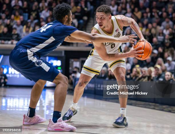 Mason Gillis of the Purdue Boilermakers holds the ball against Zach Hicks of the Penn State Nittany Lions at Mackey Arena on January 13, 2024 in West...