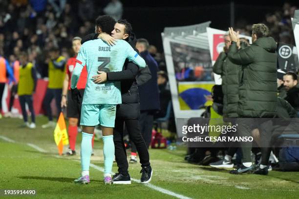 Barcelona's Spanish defender Alejandro Balde celebrates scoring his team's third goal with Barcelona's Spanish coach Xavi during the Spanish Copa del...