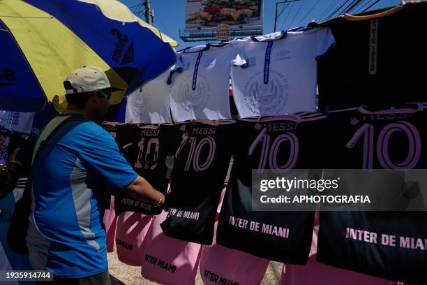 Man checks Miami FC jerseys from Argentine player Lionel Messi at an avenue ahead of tomorrow's friendly match between El Salvador and Inter Miami on...