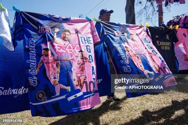 Miami FC jerseys of Argentine player Lionel Messi are displayed for sale at an avenue ahead of tomorrow's friendly match between El Salvador and...