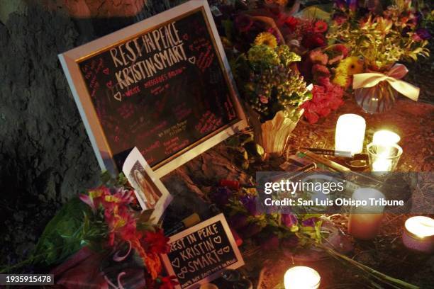 Cal Poly students laid out flowers, lit candles, burned essence and wrote well-wishing notes on a chalkboard to Kristin Smart and her family during a...