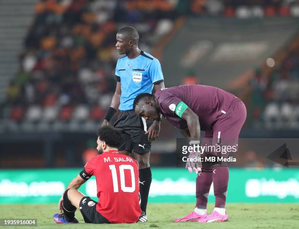 Ghana goalkeeper Richard Ofori checks on Mohamed Salah of Egypt as he sits on the floor with an injury during the TotalEnergies CAF Africa Cup of...