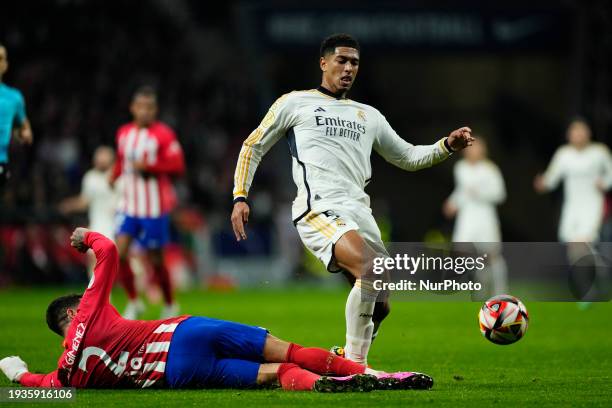 Jude Bellingham central midfield of Real Madrid and England and Jose Maria Gimenez centre-back of Atletico de Madrid and Uruguay compete for the ball...