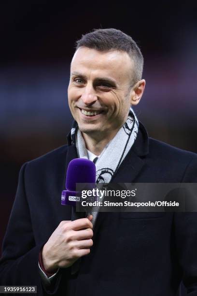 Former player Dimitar Berbatov laughs and smiles as he works for beIN Sports television during the Premier League match between Manchester United and...