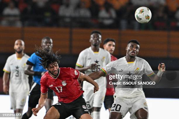 Egypt's midfielder Mohamed Elneny fights for the ball with Ghana's midfielder Mohamed Kudus during the Africa Cup of Nations 2024 group B football...