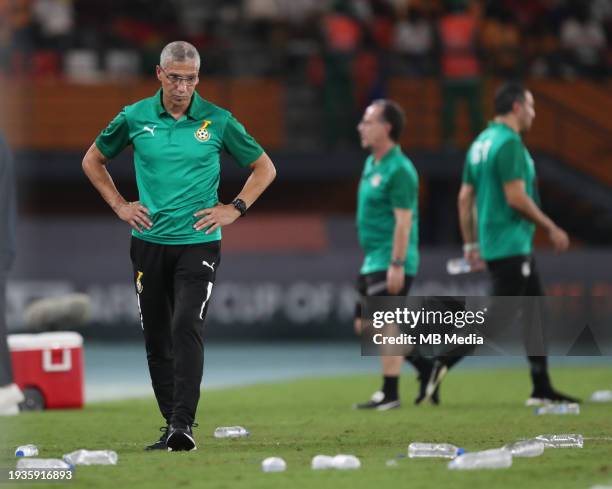 Ghana Manager Chris Hughton looks to the floor where loads of water bottles are left during the TotalEnergies CAF Africa Cup of Nations group stage...