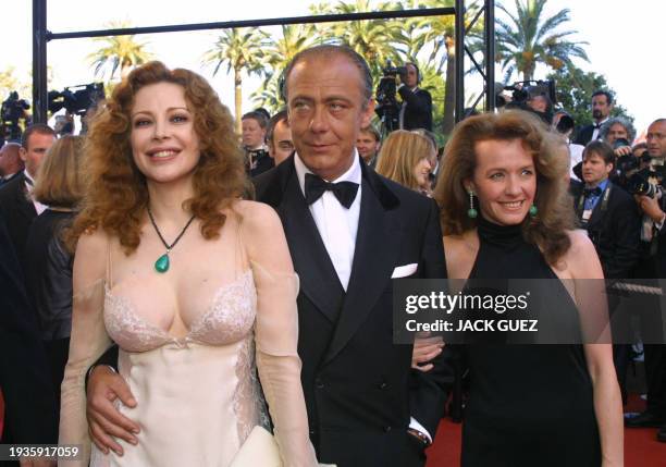 The owner of jewelery maison, Chopard, Caoline Gruosi Scheufele, his husband and Italian actress Francesca Dellera arrive at the Palais des...