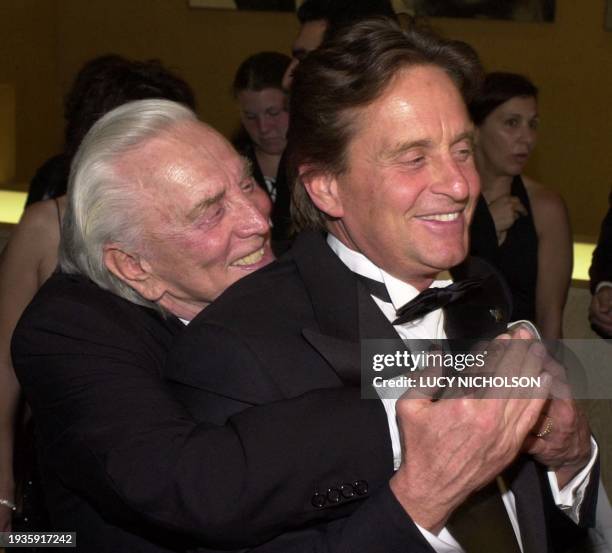 Actor Kirk Douglas hugs his son, US actor/producer Michael Douglas , as they arrive at the Simon Wiesenthal Center Museum of Tolerance National...