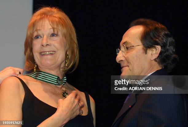 British actress Vanessa Redgrave receives her medal from French Ambassador Daniel Bernard at the French Institute in London Tuesday 13 March 2001....