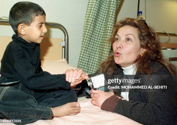 Syrian actress Raghda visits an Iraqi child at the Qasr al-Ayni hospital in Cairo 14 February 2001. Six Iraqi children suffering from syndromes...