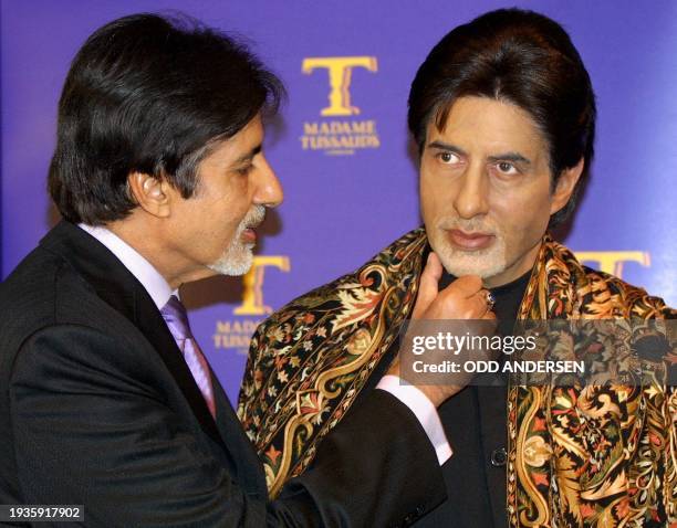 Bollywood megastar Indian actor Amitabh Bachchan feels the texture of his wax figure moustache during an unveiling ceremony at the Madame Tussaud's...