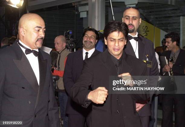 Indian new wave actor Shah Rukh Khan arrives with bodyguards at the first International Indian Film Awards 24 June 2000 at London's Millennium Dome....