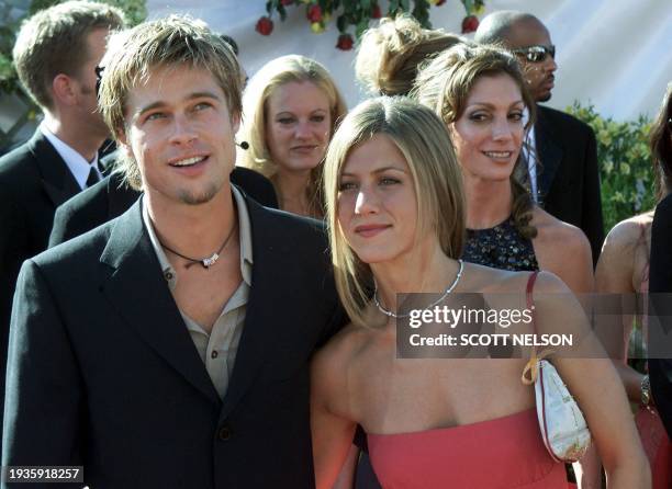 Actress Jennifer Aniston nominated for "Supporting Actress, Comedy Series" for her role in the comedy "Friends" poses with her husband Brad Pitt...