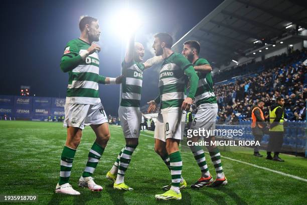 Sporting Lisbon's Portuguese forward Paulinho Dias Fernandes celebrates scoring his team's third goal with teammates during the Portuguese League...