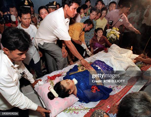 Relatives, friends and students gather at the School of Fine Arts in Phnom Penh 13 July, 1999 to mourn the loss of one of Cambodia's most popular...