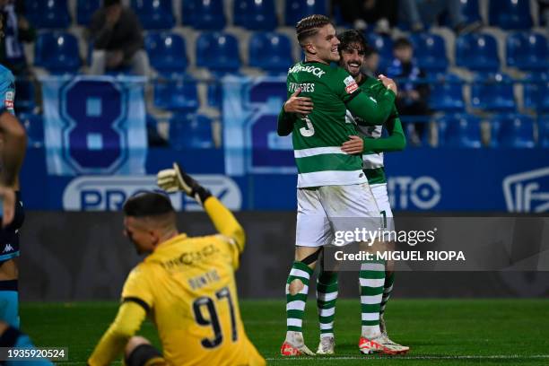 Vizela's Spanish forward Iker Unzueta celebrates scoring his team's fifth goal with Sporting Lisbon's Portuguese forward Francisco Trincao during the...