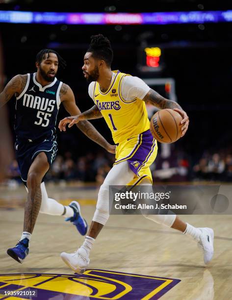 Los Angeles, CA Lakers point guard D'Angelo Russell, #1, right, drives to the hoop as Mavericks forward Derrick Jones Jr., #55, defends in the first...