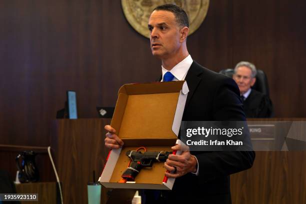 In his opening statement senior deputy district attorney Daniel Feldman displays to jury gun used by Marcus Anthony Eriz, a Costa Mesa man accused of...