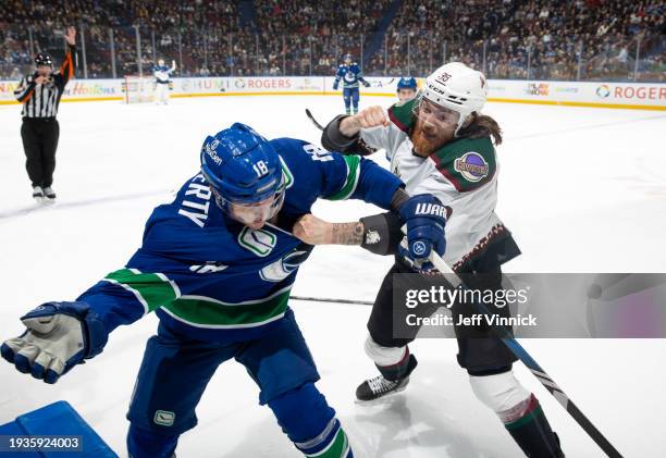 Liam O'Brien of the Arizona Coyotes and Sam Lafferty of the Vancouver Canucks tussle during the first period of their NHL game against at Rogers...