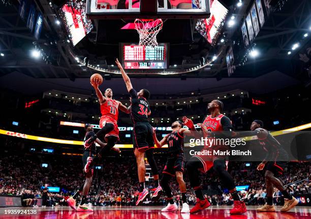DeMar DeRozan of the Chicago Bulls goes to the basket against Jontay Porter of the Toronto Raptors during the first half of their basketball game at...